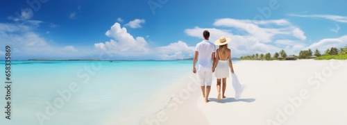 couple walking on white sand beach