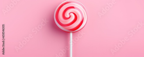 Sweet tasty pink lollipop on a pink background. Generative AI.