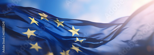 Flag of European Union waving in the breeze against a sunset sky. Banner with EU flag.