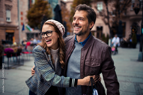 Attractive young couple walking and shopping in the city