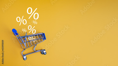 Sale percentage falling in shopping car on yellow background. Shopping online concept, Special price products, Specialand promotion.