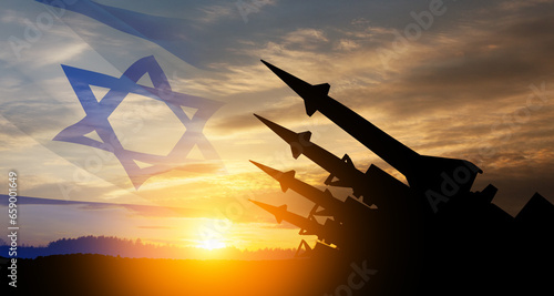 The missiles are aimed at the sky at sunset with Israel flag. Nuclear bomb, chemical weapons, missile defense, a system of salvo fire.