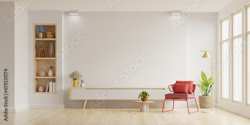 Mockup a TV wall mounted with red armchair in living room with a white wall