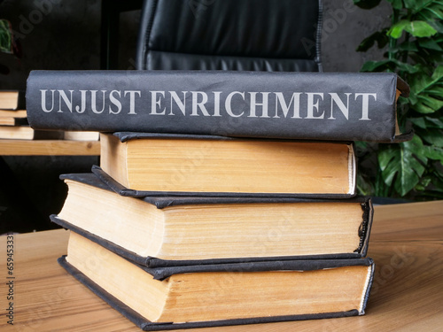 Stack of books with a law about unjust enrichment on it.