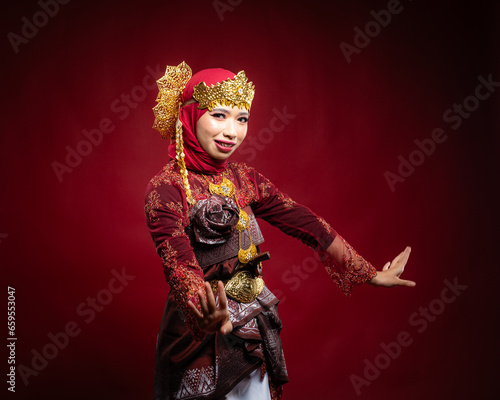 An Asian female traditional damcer wearing a traditional apparel and accessories dancing the traditional dance