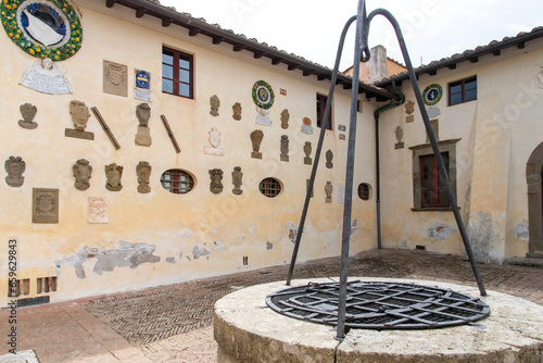 Courtyard of Castle of Lari (Castello dei Vicari) in Lari, Italy with 92 coats-of-arms of the families that lived in the castle over the centuries