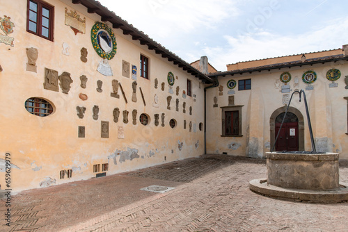 Courtyard of Castle of Lari (Castello dei Vicari) in Lari, Italy with 92 coats-of-arms of the families that lived in the castle over the centuries