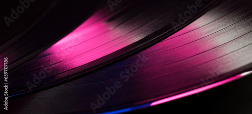 multicolored abstract music show party dj background with vinyl disc.close-up of vinyl record in blue and purple glow for background,banner.