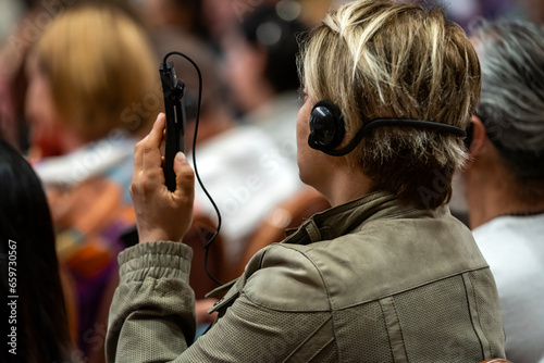  a set of headphones for simultaneous translation during negotiations in foreign languages. woman headphones used for simultaneous translation equipment simultaneous interpretation 