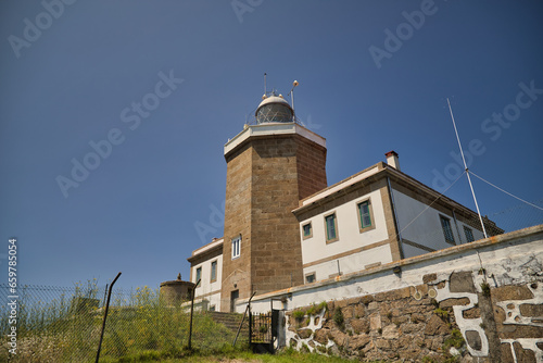Finisterre Lighthouse built in 1853 on the Atlantic coast, with a height of 138 meters above sea level, is the westernmost lighthouse in Europe. Concept coast, ocean, danger, shipwrecks.