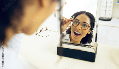 Optometry store, mirror and woman surprise over eyeglasses decision, optical clinic product or prescription eyewear. Face reflection, ocular eye care and customer shocked, wow and excited for glasses