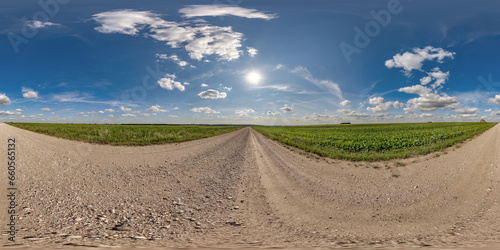 360 hdri panorama on gravel road with marks from car or tractor tires with clouds on blue sky in equirectangular spherical seamless projection, skydome replacement in drone panoramas