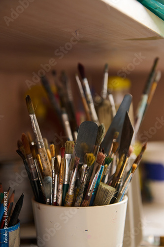 Still life with oil paintbrushes near canvas in workshop. Fine art. Visual art. Creative hobby and occupation. Painting