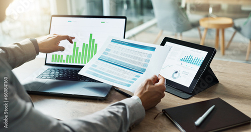 Hands, laptop and chart with paper for business man, analysis or check progress of economy, investment or profit. Financial agent, pc and reading graph for data document, growth or numbers for future