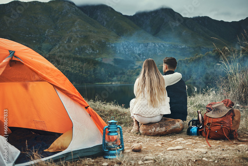 Couple, hug and relax on mountain camping, adventure or travel in nature and environment. People, tent and bonding together with embrace, support or care and tent in forest and backpacking in woods