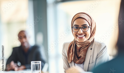 Muslim businesswoman leading a discussion during an meeting in a creative office. Group of multicultural businesswomen having a video conference with their business associates.