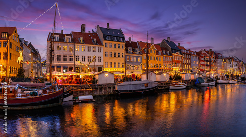 Beautiful winter evening view of the popular Nyhavn area at Copenhagen, Denmark, decorated for Christmas time