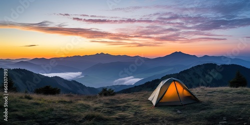 Tent amidst majestic mountains at sunset. Sunrise camping. Embracing nature beauty in mountain. Outdoor adventures. Summer under starry sky