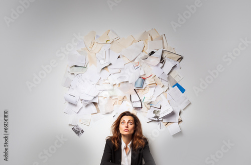 Documents cloud. Tired and sad young woman sitting under a cloud of documents. Visualization of tasks and thoughts. Office items. White background. Copy space. Generative AI