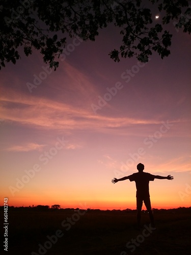 silhouette of a person in a sunset