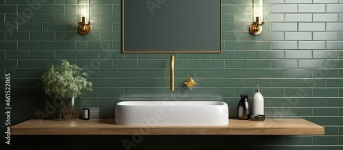Green subway tile walls gold lights marble sink and gold faucet in bathroom With copyspace for text