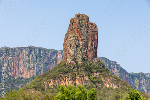 Exploring the Serrania de Chochis with the gigantic reddish rock formation Torre de David near the picturesque village Chochis near Santa Cruz de la Sierra in Bolivia - Traveling South America