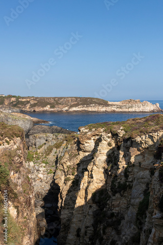 The Rugged Beauty of a Cliffside Coastline Under a Clear Blue Sky