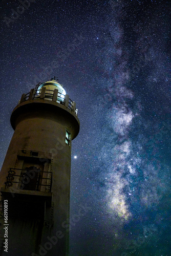 lighthouse and milky way at night in japan