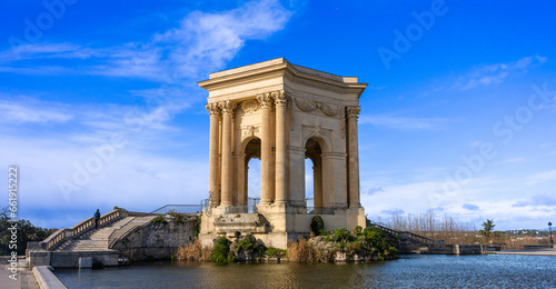 Montpellier, France - January 16 2023 - The Château d’eau du Peyrou at the Bassin principal du Peyrou. The water building and pond at the promenade du Peyrou