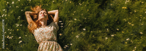 Happy woman enjoying life and nature. Resting in grass in green garden, above top view. Woman lying down relaxing in the nature. Lazy girl day dreaming outside in the park. Happy calm healthy 