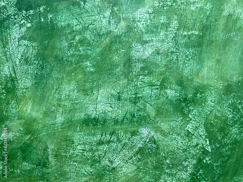 Green plaster wall with crackle texture background in Oaxaca, Mexico.