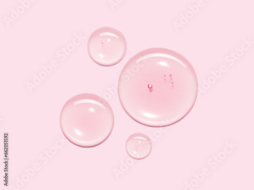Serum oil sample swatch round shape texture isolated on pastel pink background. cosmetic Hyaluronic acid retinol collagen science lab product