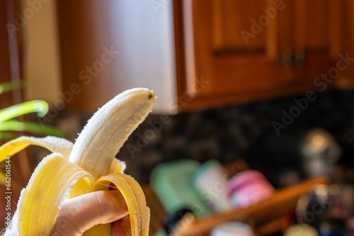 peeled banana with a bite ready to eat