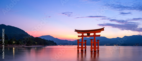 Panoramic view of Itsukushima Shrine's torii gate at Miyajima in Hiroshima at magic hour.