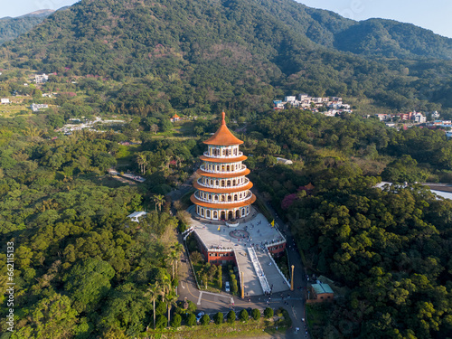 Aerial view of Wuji Tianyuan Temple by drone in Tamsui, New Taipei City, Taiwan. Beautiful weather, blue sky and mountains.