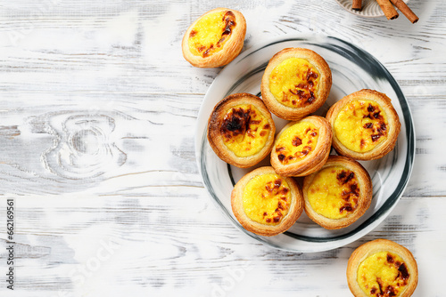 Pastel de nata or Portuguese egg tart. Small tart with a crispy puff pastry crust and a custardy pastry cream filling, top view