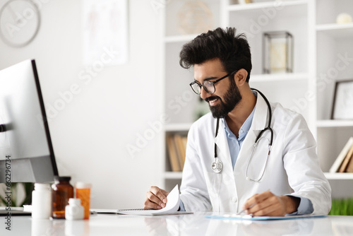 Indian Doctor Engaged in Work at Clinic Computer