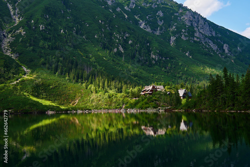 View on cabin in mountains with green forest. House for tourists in Tatra National Park near Morskie Oko or Eye Sea lake. Touristic place in Poland