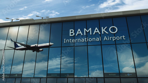 Airplane landing at Bamako Mali airport mirrored in terminal