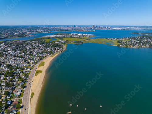 Wollaston Beach aerial view and Quincy Shore Drive next to the beach in Quincy Bay with Boston modern skyline at the background in Wollaston, city of Quincy, Massachusetts MA, USA. 