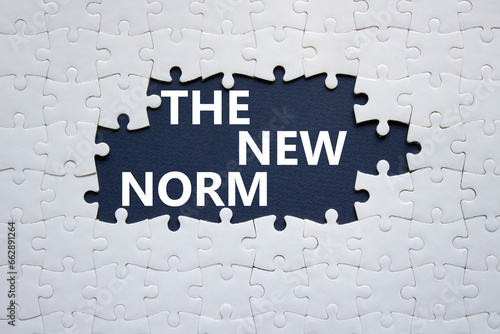 The new norm symbol. Concept words The new norm on white puzzle. Beautiful dark blue background. Business and The new norm concept. Copy space.
