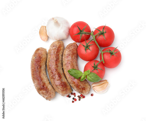 Tasty homemade sausages, peppercorns, tomatoes, garlic and basil leaves isolated on white, top view