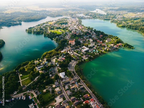 Aerial view of the picturesque Trakai, Lithuania, surrounded by a tranquil lake and lush greenery