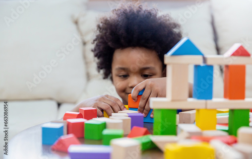 Little boy hands of little children play blocks in classroom. Learning by playing education group study concept. International pupils do activities brain training in primary school background banner