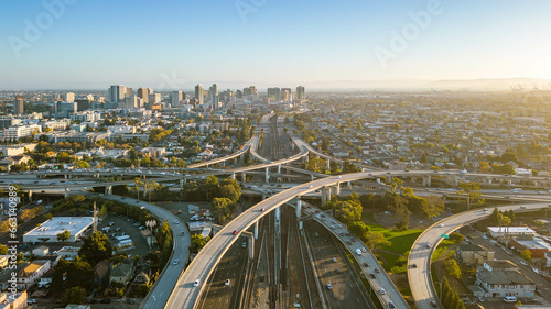 A drone view over the freeway cypress in Oakland, California during sunset with the downtown in the background.