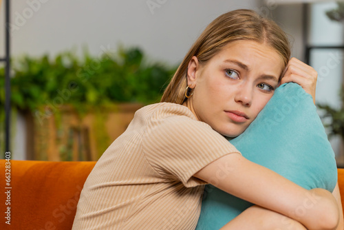 Sad lonely woman lying down on pillow at home looks pensive thinks over life concerns, unrequited love suffers from unfair situation. Alone girl problem break up, depressed feeling bad annoyed burnout