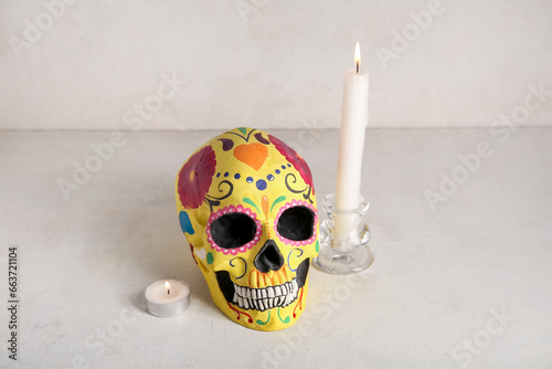 Candles with painted skull on white grunge background. Celebration of Mexico's Day of the Dead (El Dia de Muertos)