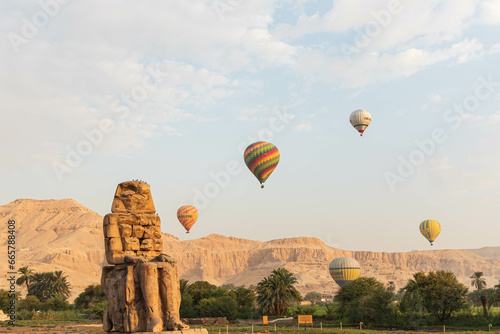 Colossi of Memnon in Egypt: Majestic ancient statues guarding the historical wonders of Luxor, echoing the Pharaoh's enduring legacy.