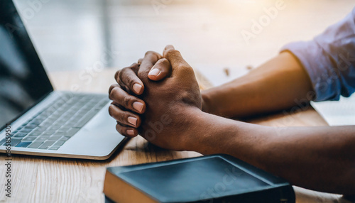 hands together in prayer for god blessing to wish to have a better life man hands praying to god with the bible on his laptop believe in goodness spirituality and religion and bible prayer online