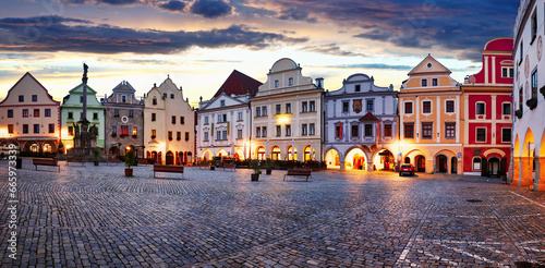 Scenery of the Plaza in Cesky Krumlov, a medieval town in Czech Republic with colorful houses, monument in the square before sunrise. Czech republic